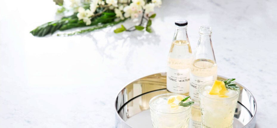 Marble kitchen countertop with a polished nickel tray and two tonic waters