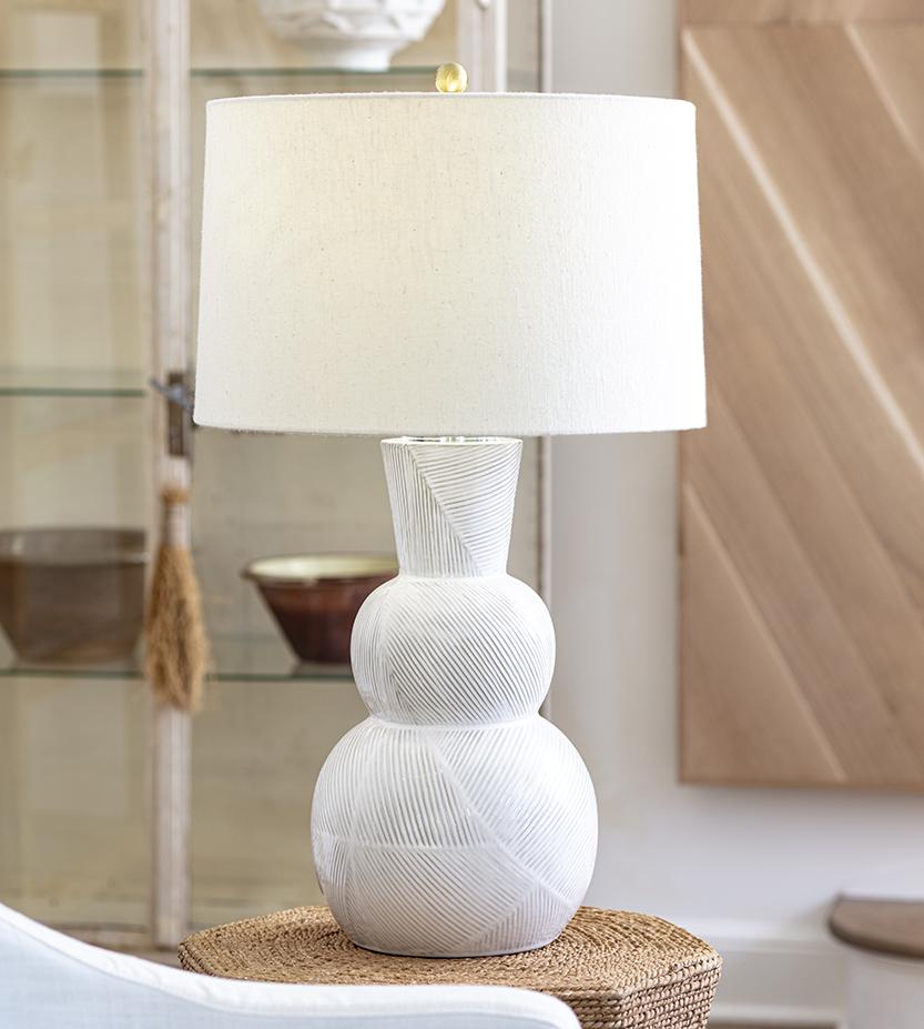 Modern white ceramic table lamp with a linen lamp shade