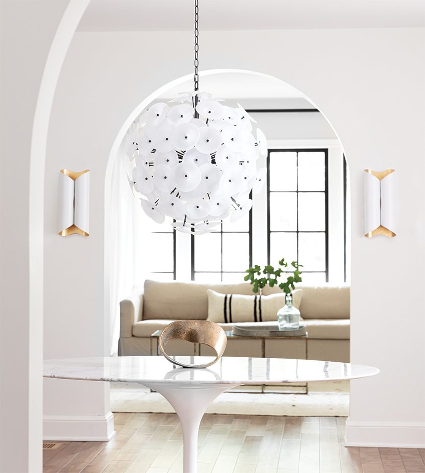 Entryway with a white marble topped table, and a black and white poppy chandelier