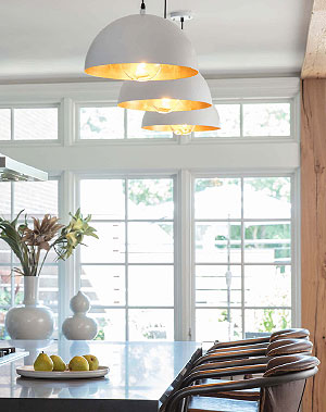 Three white pendants above a bar table