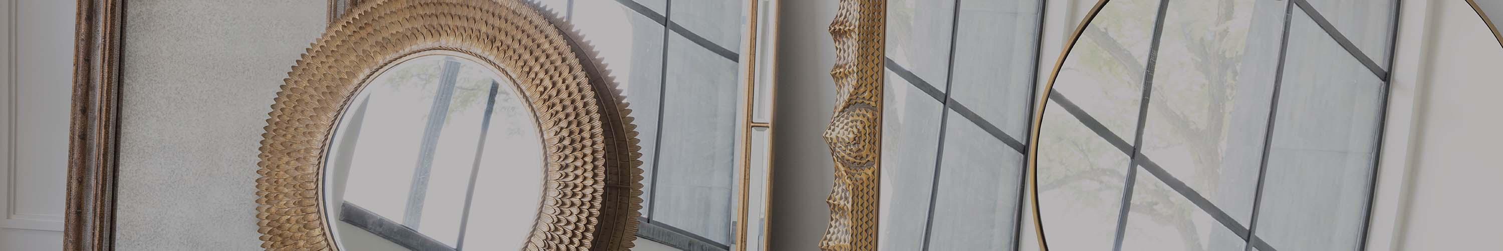 A collection of different styled mirrors leaning against one another