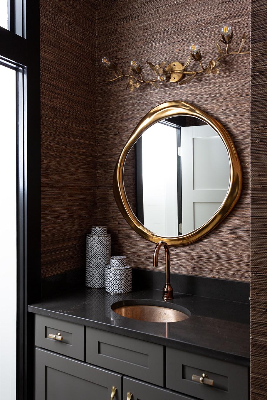  Charcoal Bathroom vanity with a gold mirror and gold plainted sconce