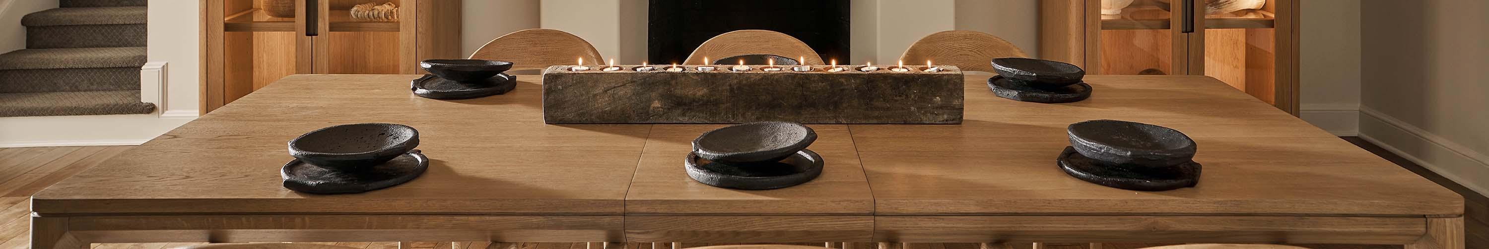 Wood dining table with gray plate settings