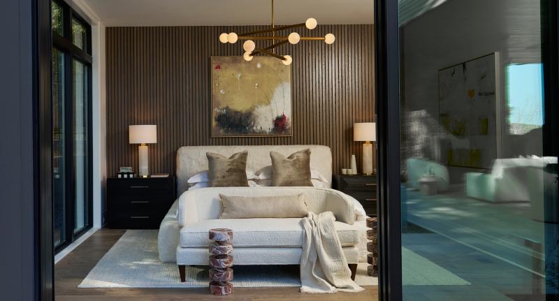 indoor outdoor bedroom with a bed chandelier and side tables