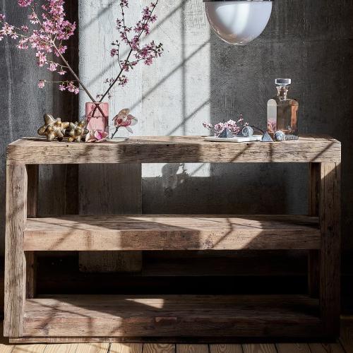 Wood console table holding flowers