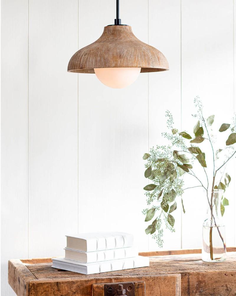 Natural wooden console table with white books and a natural wooden coastal styled pendant with a glazed bulb