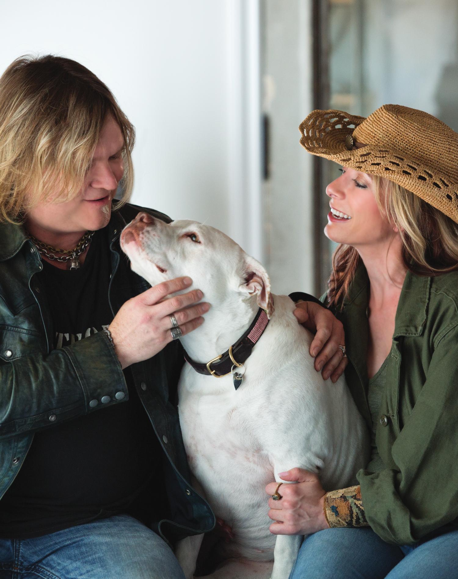Carla and Regina of Regina Andrew sitting next to their dog Baby