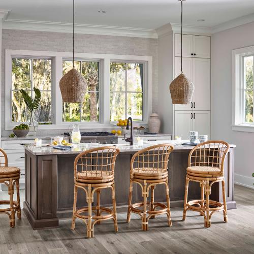 wicker counter stools in front of a marble kitchen island