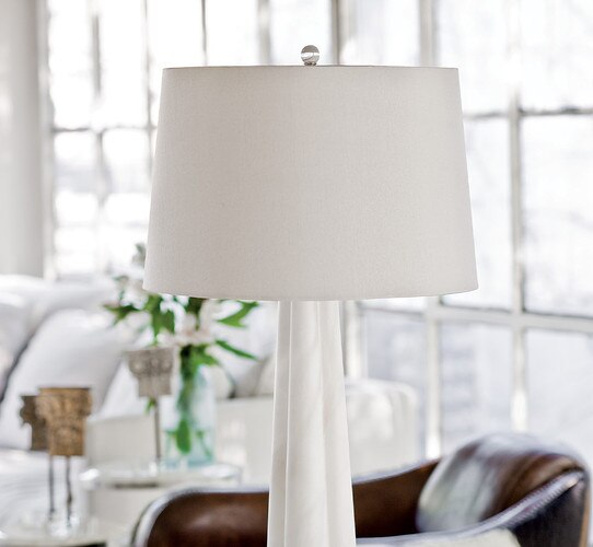 Alabaster table lamp in front of a brown leather chair