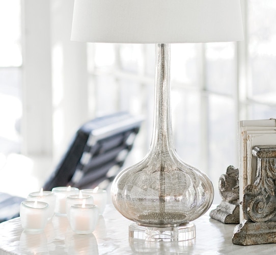 Antique mercury table lamp next to votive candles