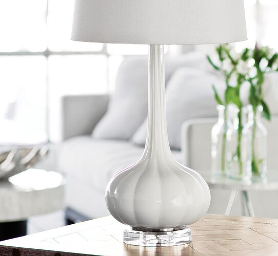 White table lamp on wooden side table