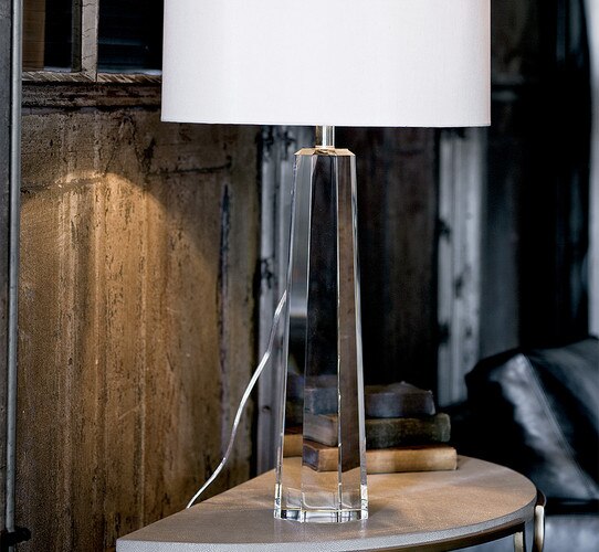 Solid crystal table lamp on a console table