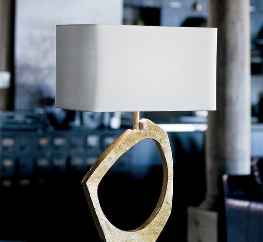 Sculptural gold leaf table lamp with a white linen shade