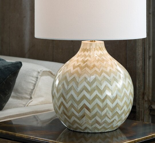 Beige and white bone table lamp on a wood side table