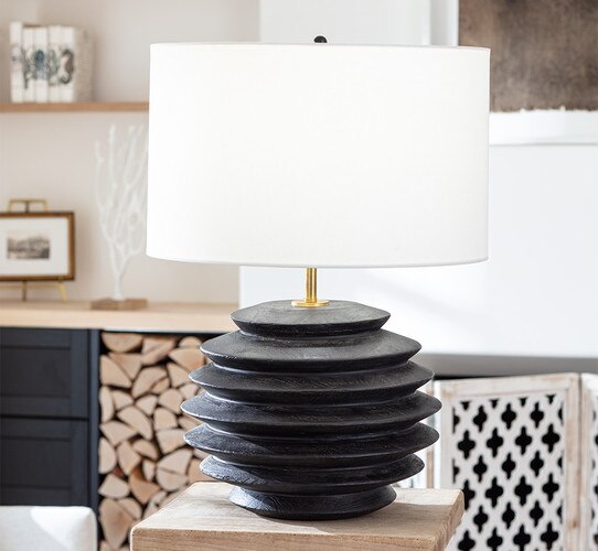 Black organically textured table lamp on a wooden side table