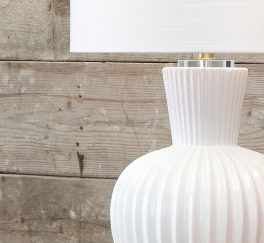 Textured white ceramic lamp with a flared base