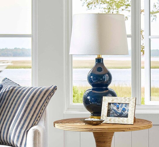 Navy ceramic table lap on a wicker side table