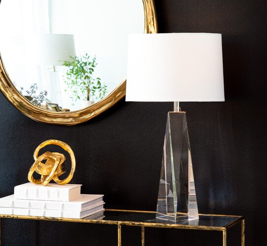 Tapered crystal table lamp on a console table