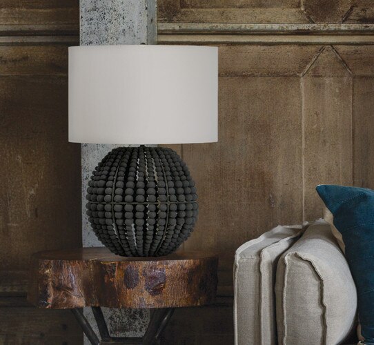 Grey beaded table lamp on a wooden side table