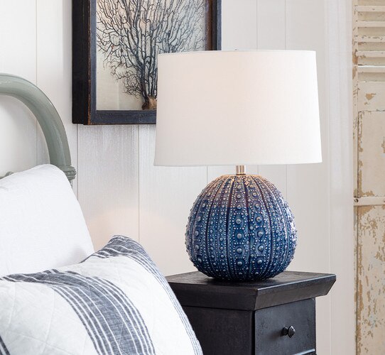 Blue textured table lamp on a wood side table