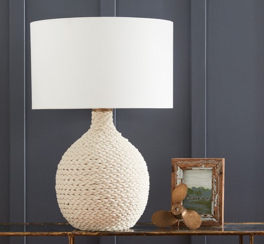Table lamp with knotted design on a console table