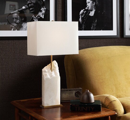 Alabaster table lamp with a raw top on a wooden side table