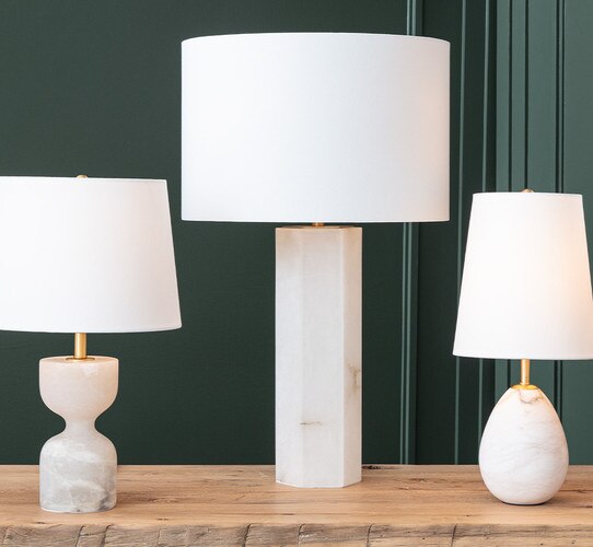 Tall geometric alabaster table lamps next to two alabaster mini lamps