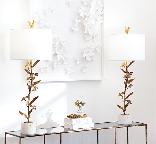 Tall flower buffet lamp with an alabaster base on a console table