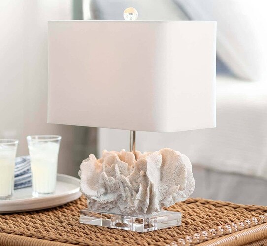 Coral table lamp on a wicker side table