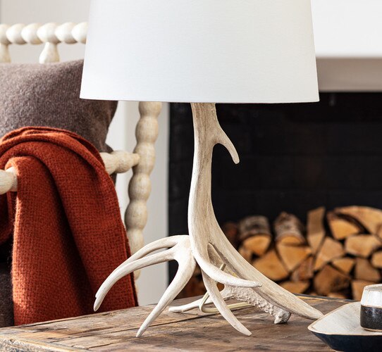 Antler table lamp on a wood side table