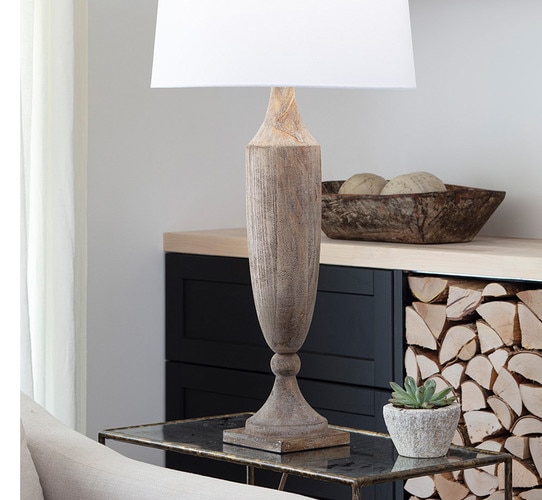 Thin rustic wood table lamp on a side table