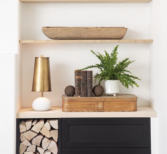 White and brass concrete mini lamp on a built in next to a decorative tray