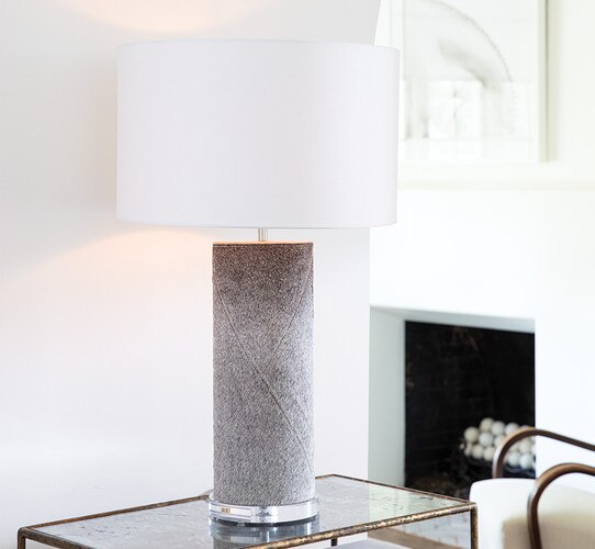 Gray table lamp on a gold console table