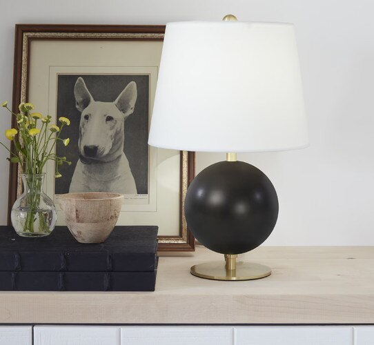 Black circular mini lamp on a built in shelf