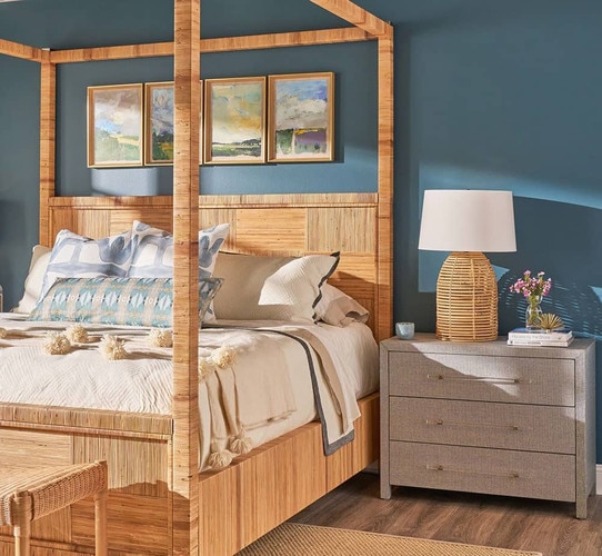 Rattan bed in a blue bedroom with a nightstand