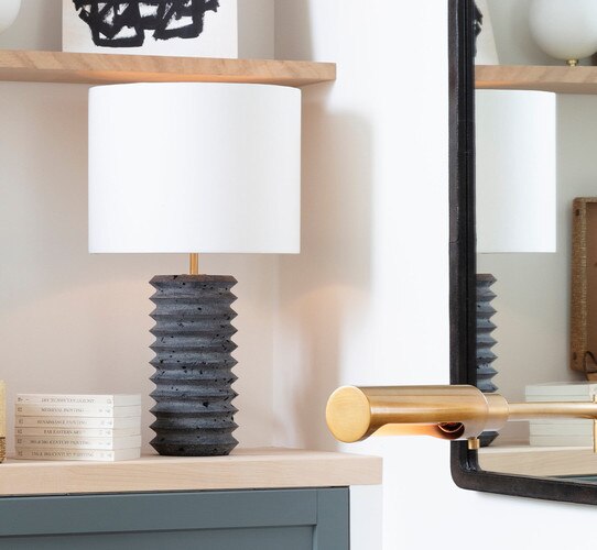 Black travertine lamp on a built in shelf