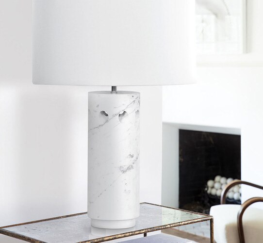 White marble table lamp on a zinc and gold console table