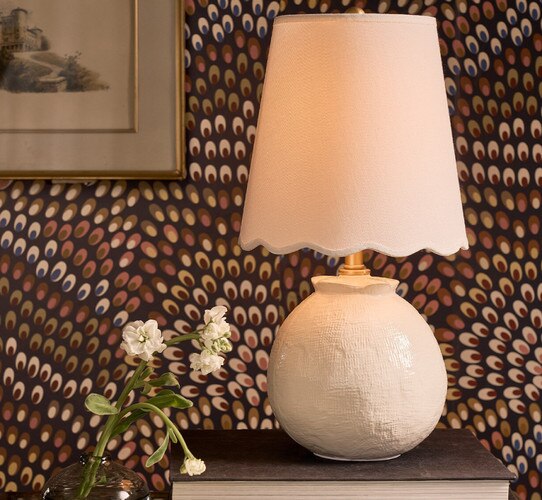 Small scalloped mini lamp on a book next to flowers