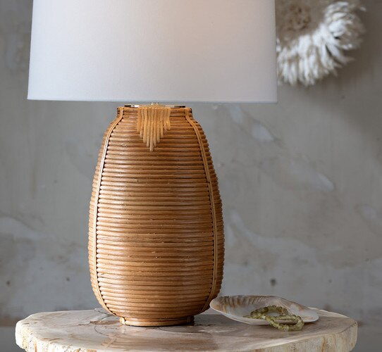 Rattan table lamp on a petrified wood side table