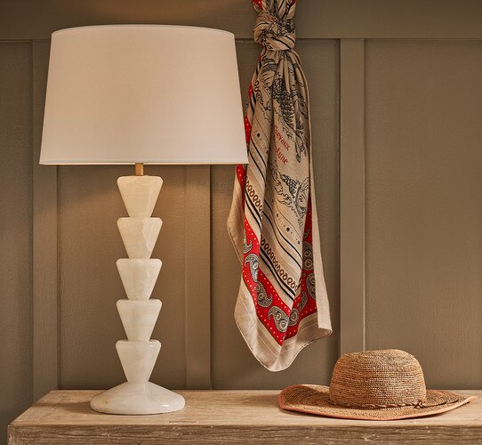 Tiered jade table lamp on a wood console table next to a scarf