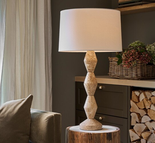 Travertine buffet lamp on a marble and wood side table