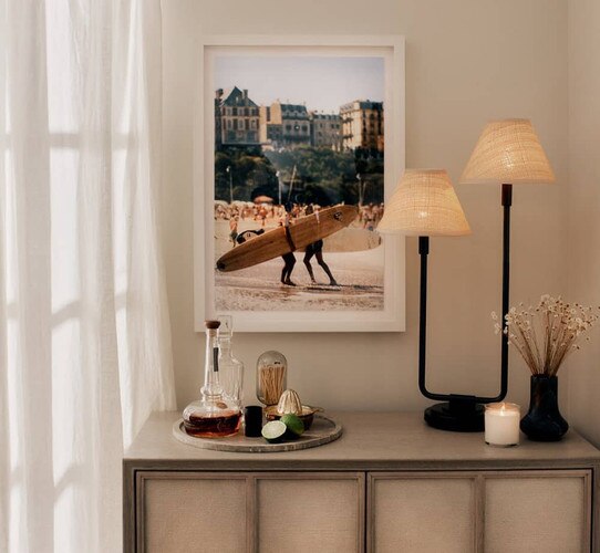 Black and rattan double table lamp on a sideboard
