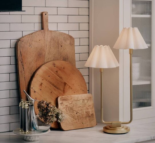 Natural brass lamp with a white shade on a marble counter