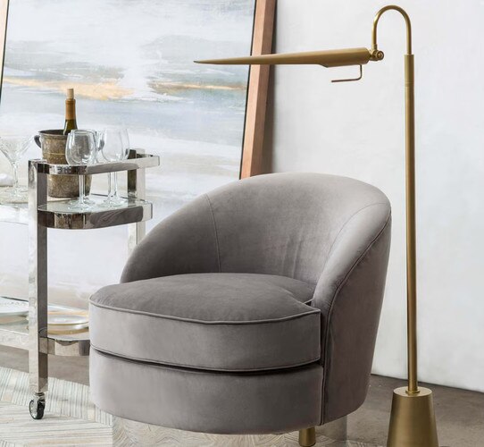 A brass task beside a gray chair