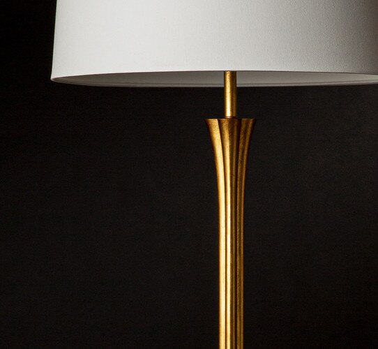 Gold lamp with a white linen shade