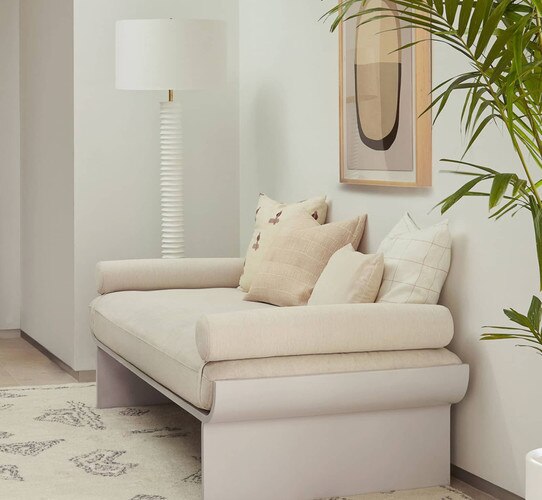White textured lamp beside a linen day bed