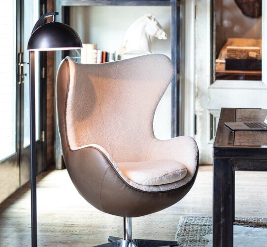 Bronze task lamp next to a sheepskin desk chair