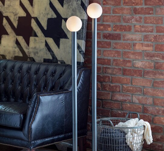 Modern black lamp next to leather sofa