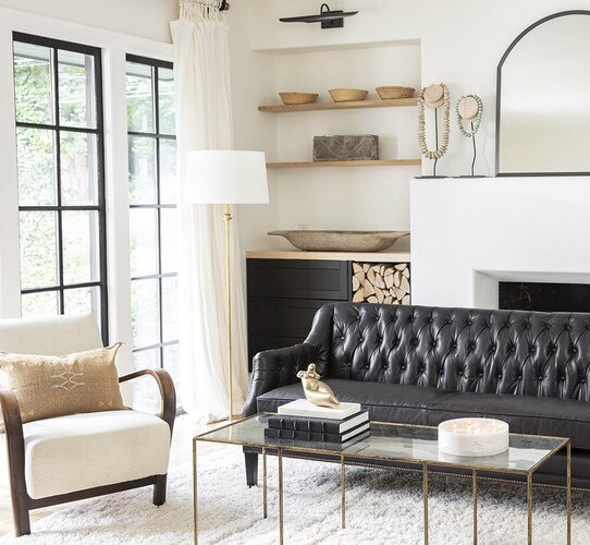 Traditional brass lamp next to leather sofa in a living room