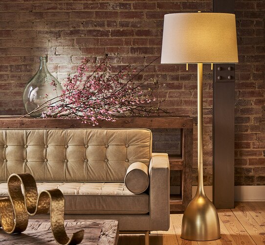 Natural brass lamp beside white leather sofa